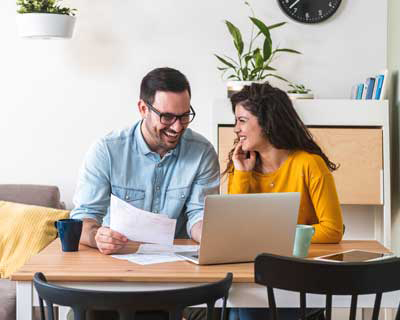 HELOC-billpay couple sitting at computer to pay bills together