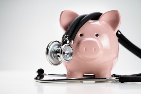 piggy bank with stethoscope