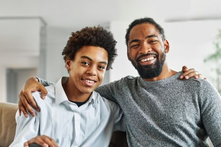 happy African American father and teen son