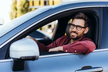 happy man driving a car